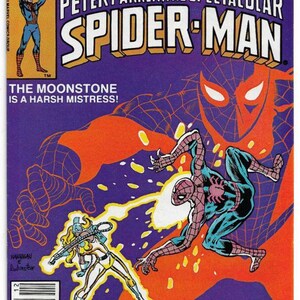 May include: Comic book cover featuring Spider-Man in action, with the text "SPIDER-MAN" in large, bold letters. The cover includes the text "THE MOONSTONE IS A HARSH MISTRESS!" and the Marvel Comics Group logo.