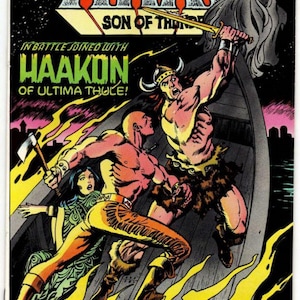May include: A vintage Arak Son of Thunder comic book issue number 18 from February. The cover features a colorful illustration of a warrior with a horned helmet and a bald fighter in a boat, with text reading Arak Son of Thunder and Haakon.