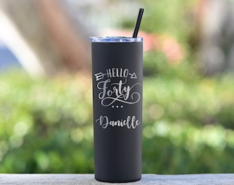 May include: Black stainless steel tumbler with a white inscription that reads "Hello Forty Danielle".