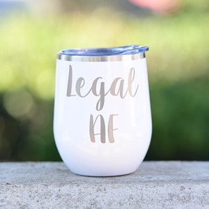 May include: White stainless steel wine tumbler with a silver inscription that reads "Legal AF".