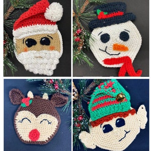 May include: Four crocheted Christmas decorations: Santa Claus, snowman, reindeer, and elf. Each decoration is made with yarn in various colours, including red, white, green, brown, and beige. The decorations are adorned with details such as a Santa hat, a snowman's carrot nose, reindeer antlers, and an elf's hat.