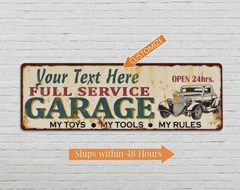 May include: A vintage-style metal sign with a rusty look, featuring the text "Your Text Here FULL SERVICE GARAGE OPEN 24hrs. MY TOYS MY TOOLS MY RULES". The sign has a red, white, and blue color scheme and depicts a classic car.
