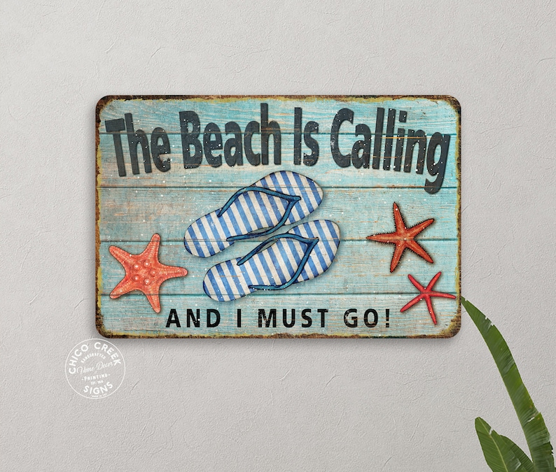 May include: A blue and white wooden sign with the text "The Beach Is Calling And I Must Go!"  The sign features two blue and white striped flip flops and three red starfish.