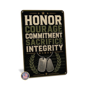 May include: A rectangular metal sign with a black background featuring the words HONOR, COURAGE, COMMITMENT, SACRIFICE, and INTEGRITY in tan. Below the text are two silver dog tags on a chain, a laurel wreath graphic, and a small US flag emblem.