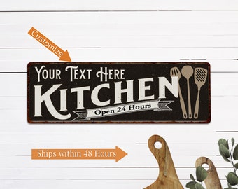 May include: Black and white metal sign with the text "YOUR TEXT HERE KITCHEN Open 24 Hours" and three kitchen utensils on the right side.