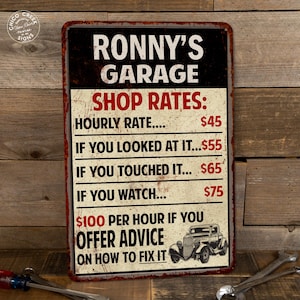 May include: A rusty red metal sign with the text "Ronny's Garage Shop Rates:" and a price list for hourly rates, looking at it, touching it, and watching. The sign also says "$100 per hour if you offer advice on how to fix it". A vintage car is pictured at the bottom of the sign.
