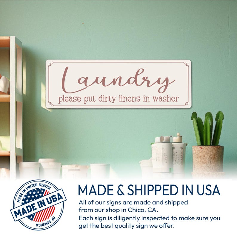 May include: A cream-coloured rectangular sign with the word "Laundry" in a cursive font and the phrase "please put dirty linens in washer". The sign has a decorative border and is mounted on a light green wall, suitable for a utility room.