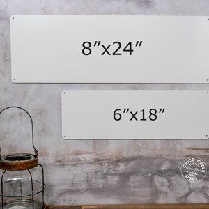 May include: Two white metal signs with black text. The top sign reads "8"x24" and the bottom sign reads "6"x18".