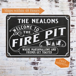 May include: Black and white metal sign with the text "The Nealons Welcome to the Fire Pit" and the text "Where marshmallows and friends get toasted". The sign has a rustic design with a wood grain background.