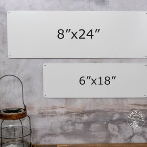 May include: Two white metal signs with black text. The top sign reads "8"x24" and the bottom sign reads "6"x18".