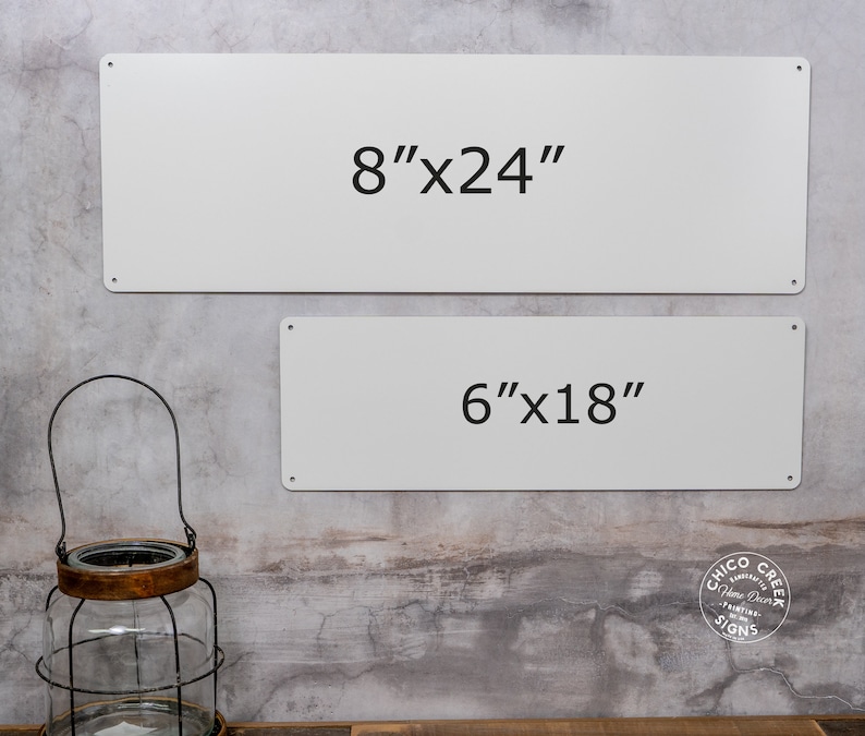 May include: Two white metal signs with black text. The top sign reads "8"x24" and the bottom sign reads "6"x18".