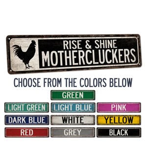 May include: A rustic metal sign with a black rooster silhouette and the text "Rise & Shine Mothercluckers". Choose from the colours below: green, light green, light blue, pink, dark blue, white, yellow, red, grey, black.