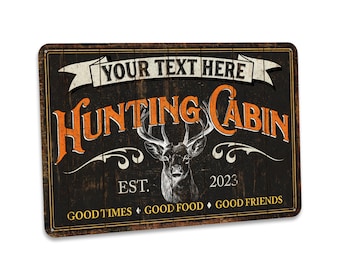 May include: A rustic wooden sign with the text "Hunting Cabin" in orange letters. The sign also features a deer head illustration, the text "Your Text Here", "Est. 2023", and "Good Times, Good Food, Good Friends".