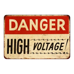 May include: A vintage-style metal sign with a red background and white text that reads "DANGER HIGH VOLTAGE!" The sign has a distressed, rusty look.