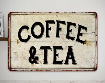 May include: A vintage-style metal sign with a white background and black lettering. The sign reads "COFFEE & TEA".