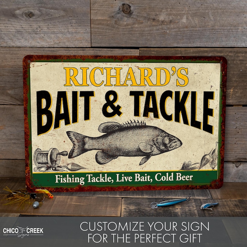 May include: A vintage-style metal sign with a rustic, weathered look. It features the text "Richard's Bait & Tackle" in black and yellow lettering, with a black and white illustration of a fish. The sign also includes the text "Fishing Tackle, Live Bait, Cold Beer" in green lettering.