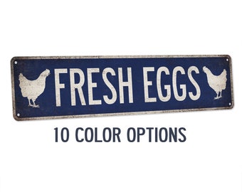 May include: A blue metal sign with white text that reads "FRESH EGGS" and a white silhouette of a chicken on each side. The sign has a distressed look and is available in 10 color options.