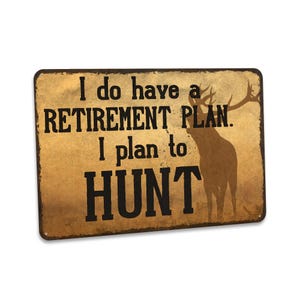 May include: A rustic brown metal sign with the text "I do have a retirement plan. I plan to hunt."  A silhouette of a deer is in the background.