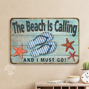 May include: A blue and white wooden sign with the text "The Beach Is Calling And I Must Go!"  The sign features two pairs of flip flops, two red starfish, and a blue and white wooden background.