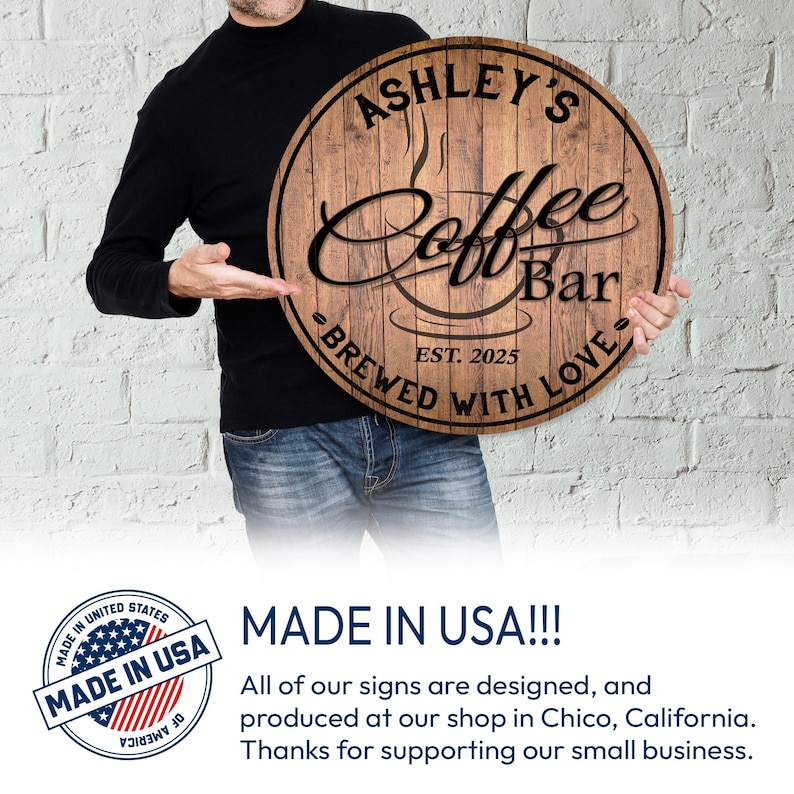May include: A round wooden sign with the text "Ashley's Coffee Bar" in a stylized font. The sign also includes the text "Brewed with Love" and "Est. 2025". The sign is brown with a coffee cup design.