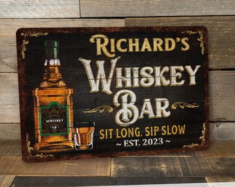 May include: A rustic-style metal sign with a black background and gold lettering. The sign reads "Richard's Whiskey Bar" with the text "Sit Long, Sip Slow ~ Est. 2023 ~" below. The sign features a cartoon illustration of a bottle of whiskey and a shot glass.