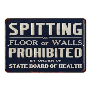 May include: A blue and white metal sign with the text "SPITTING ON FLOOR OR WALLS PROHIBITED BY ORDER OF STATE BOARD OF HEALTH".