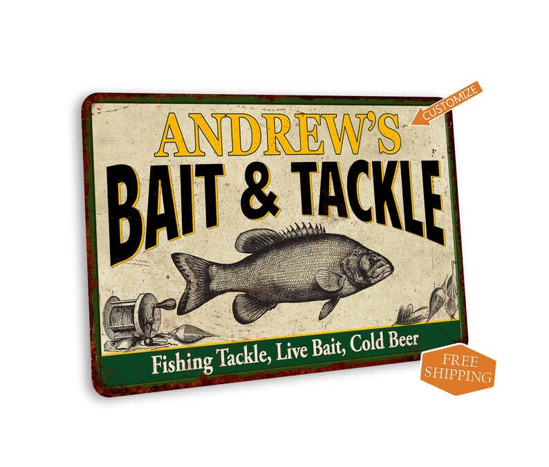 May include: A vintage-style metal sign with a green border and a white background. The sign says "Andrew's Bait & Tackle" in black lettering with a yellow outline. A black and white illustration of a fish is shown below the text. The sign also says "Fishing Tackle, Live Bait, Cold Beer" in black lettering.