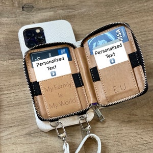 May include: White phone case with a zippered wallet attached. The wallet has two card slots and a zippered compartment. The phone case has a white strap attached. The wallet has the text "My Family Is My World" and "E.U" printed on it. The card slots have the text "Personalized Text" printed on them.