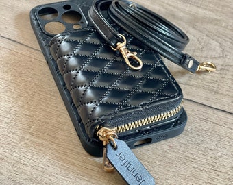 May include: Black quilted phone case with a zippered pocket and a gold chain strap. The case has a gold zipper and a small black leather tag with the word "Jennifer" on it.