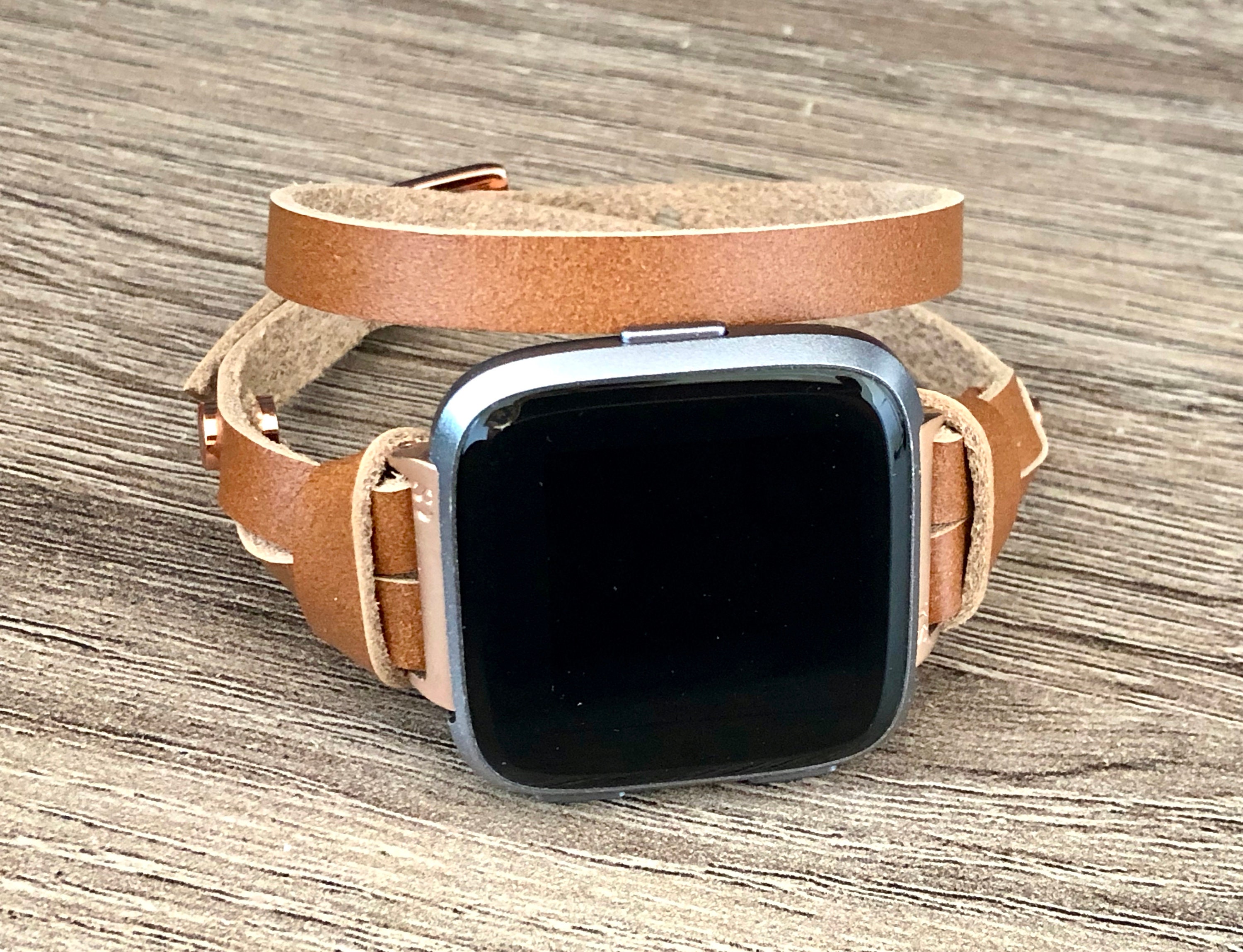 rose gold fitbit versa with different bands
