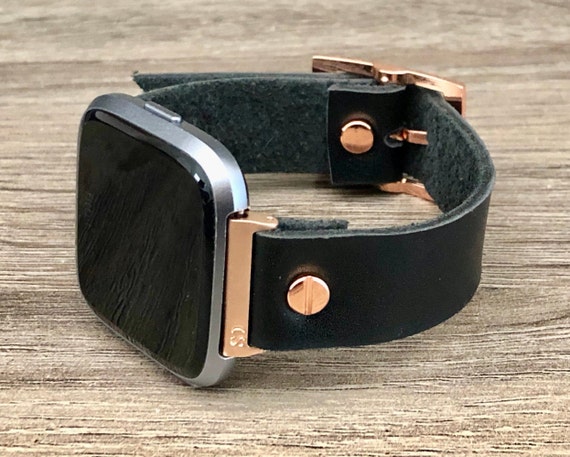 rose gold fitbit versa with black band