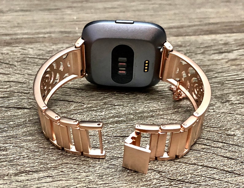 rose gold fitbit versa with different bands