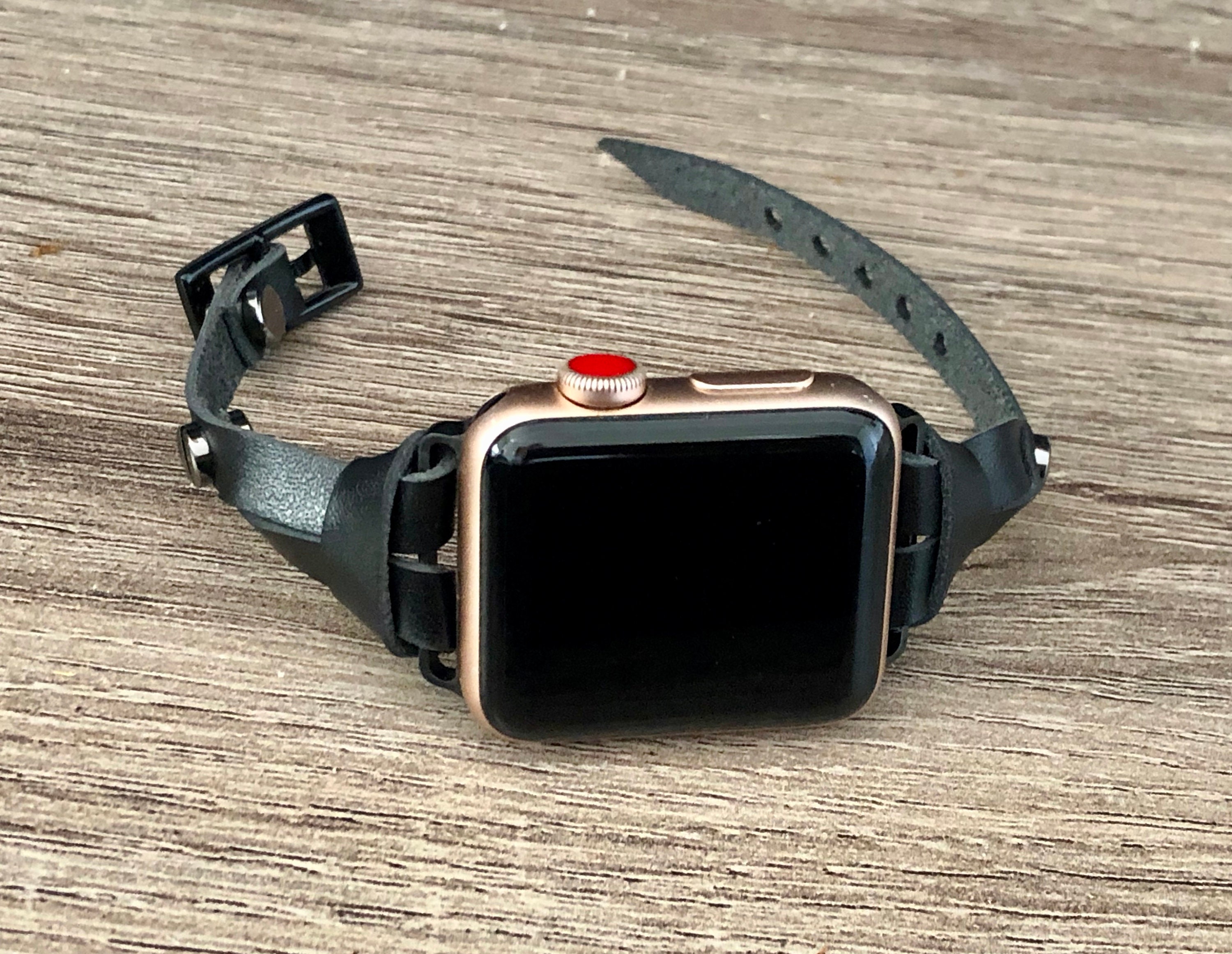 space gray apple watch with leather band