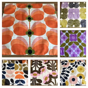 May include: A collection of fabric swatches featuring retro floral and geometric patterns. The designs include large orange and pink flower shapes, purple and green floral arrangements, and other colorful botanical motifs on a white background.