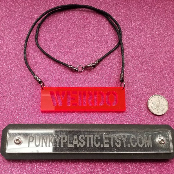 Acrylic WEIRDO stamp effect cut out letters necklace.