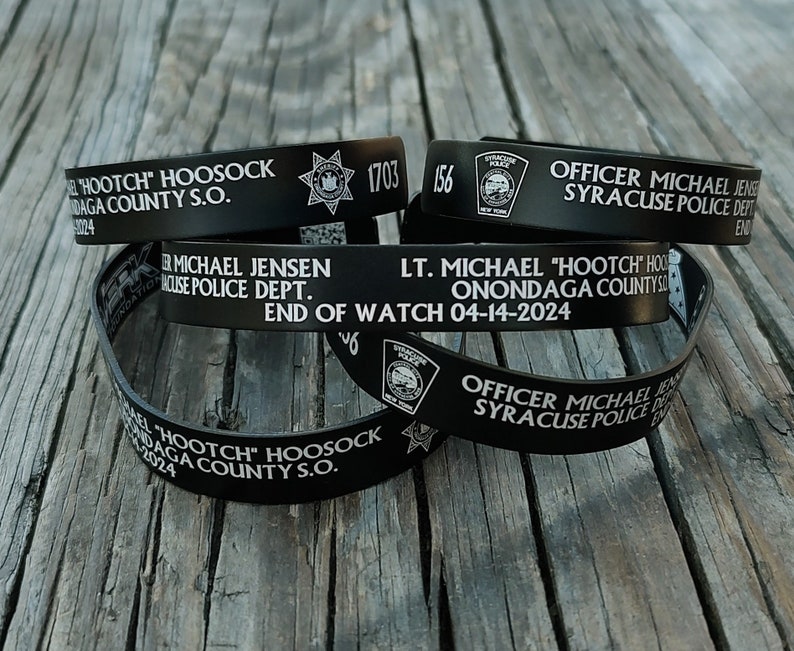 L'officier Michael Jensen et le lieutenant Michael Hoosock portent des bracelets commémoratifs, les bénéfices étant reversés aux familles. image 1