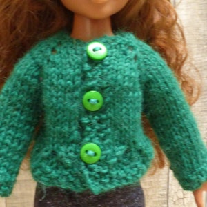 May include: A green knitted cardigan with four green buttons. The cardigan is made of a soft, fuzzy yarn.