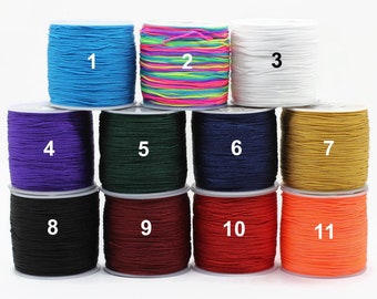 May include: Eleven spools of colorful thread, numbered 1 through 11, are arranged in two rows. The thread colors include blue, rainbow, white, purple, green, navy blue, gold, black, burgundy, red, and orange.