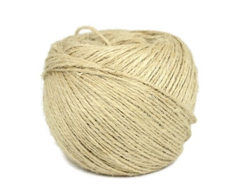 May include: A ball of natural twine made from jute fiber. The twine is a light beige color and is wound tightly into a ball shape.