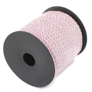 May include: A spool of pink braided cord on a black plastic bobbin.