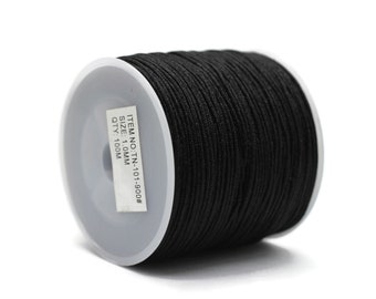 May include: A spool of black cord, likely for crafting or jewelry making, is shown against a white background. The label indicates the cord is 1.0mm in size and 100 meters in length.