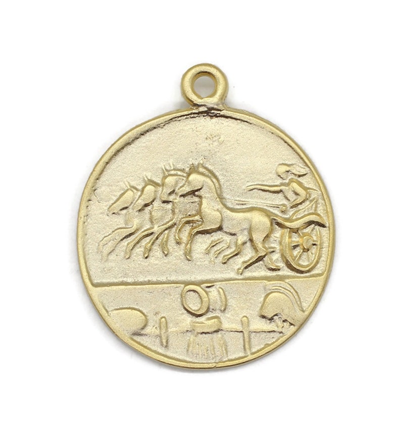 May include: Gold-toned metal charm featuring a raised design of a chariot pulled by four horses. The chariot is driven by a figure holding reins. The bottom of the charm has a raised design of a wreath and a helmet.