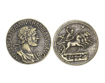May include: A bronze Roman coin with a portrait of Emperor Trajan on one side and a chariot with four horses on the other side. The inscription on the coin reads "IMP. CAESAR TRAIANVS HADRIANVS AVG."