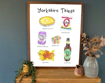 May include: A white printable poster with the title "Yorkshire Things" and illustrations of Yorkshire pudding, chips with gravy, a can of dandelion and burdock, a bag of crisps, a bottle of Yorkshire ale, and a bag of Yorkshire mix sweets.