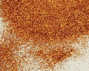 May include: A close-up of a pile of fine, sparkly copper glitter. The glitter is a warm, metallic copper color and has a fine, shimmery texture.