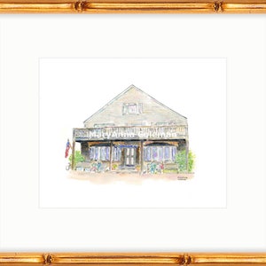 May include: Watercolor painting of a light gray house with a porch and a white picket fence. The house has a red, white, and blue American flag flying from the porch. The house is surrounded by green bushes and trees.