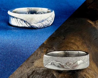 Anillo de bodas de oro con olas del océano y montañas, anillo de surfista, esquiador y snowboarder