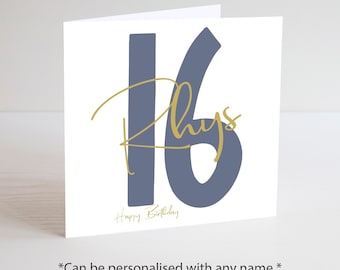May include: A white greeting card with a blue number 16 and the name "Rhys" in gold script. The words "Happy Birthday" are below the number. The card is a square shape.