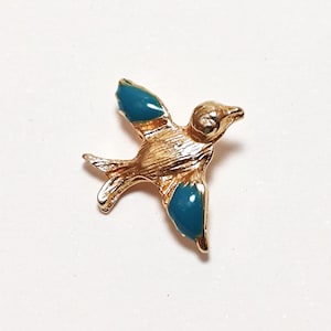 Pequeño broche vintage con forma de pájaro azul y cierre de presión