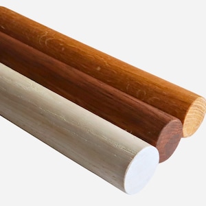 May include: Three wooden dowels with screw ends, in white, brown, and light brown.